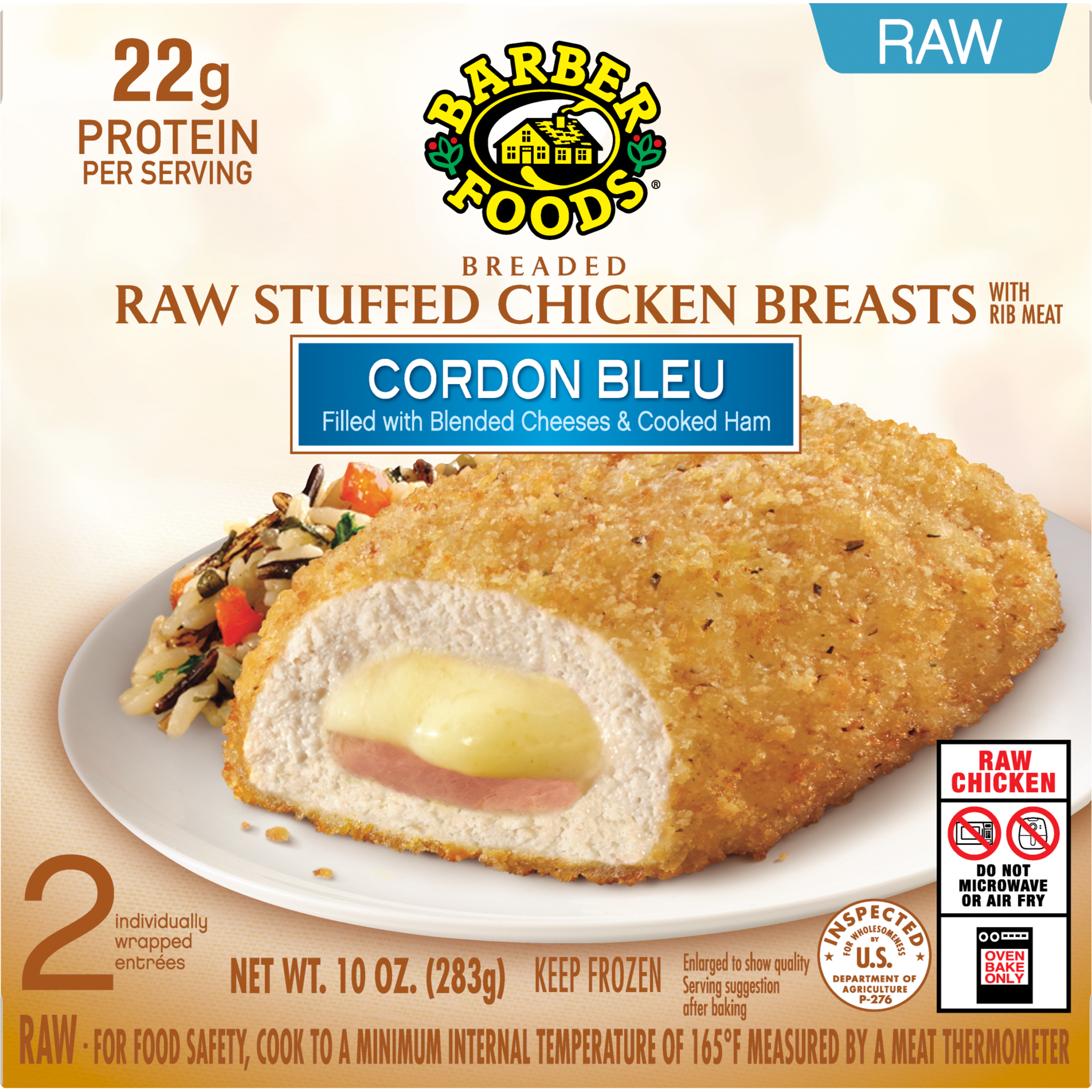 A breaded stuffed chicken breast is served on a white plate, sliced open to reveal melted cheese and ham inside. The dish sits on a wooden surface with a blurred kitchen or restaurant background. 